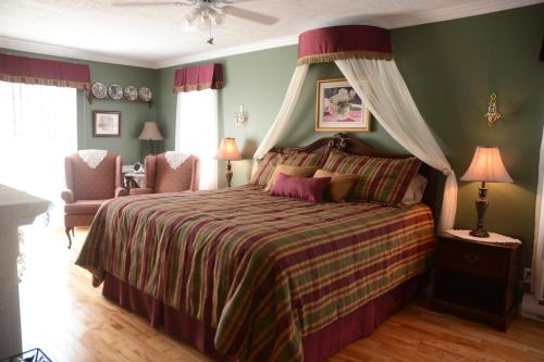 a bedroom with a bed with a green wall at Côté's Bed & Breakfast in Grand Falls