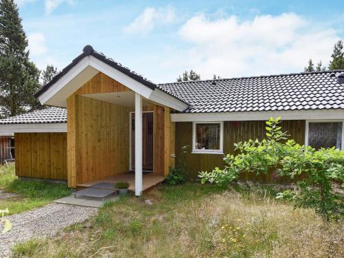 a small house with a wooden exterior at Secluded Retreat in Nature - By Traum Ferienwohnungen in Lønne Hede