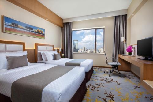 TV a/nebo společenská místnost v ubytování Kunming Jinjiang Hotel