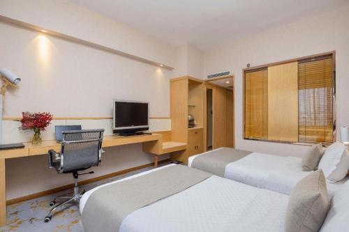 TV a/nebo společenská místnost v ubytování Kunming Jinjiang Hotel