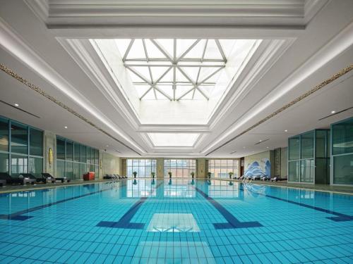 a large swimming pool with a large ceiling at Dongwu New Century Grand Hotel Huzhou in Huzhou