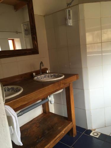 a bathroom with two sinks and a mirror at Lodge Altitud in San Pedro de Atacama