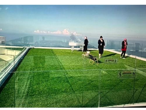 a group of people standing on the roof of a building at Highest Floor, Skyline Studio for 4Pax In Hoverland Genting Highlands in Genting Highlands