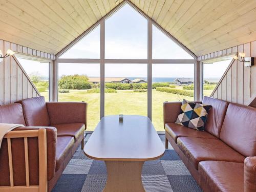 a living room with couches and a table at 10 person holiday home in Vinderup-By Traum in Vinderup
