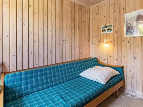 a couch in a room with wood panel walls at 10 person holiday home in Vinderup-By Traum in Vinderup