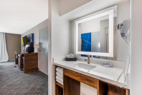 a bathroom with a sink and a mirror at Comfort Inn & Suites Ogallala in Ogallala