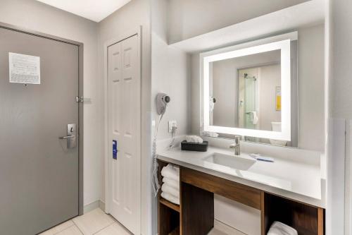 a bathroom with a sink and a mirror at Comfort Inn & Suites Ogallala in Ogallala