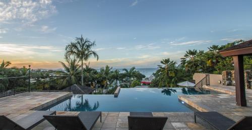 a swimming pool in a villa with a view at at Water's Edge Resort in Airlie Beach