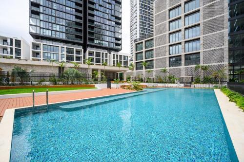 a swimming pool in front of some tall buildings at Olympic Park Stylish Apt with Gym Pool great view in Sydney
