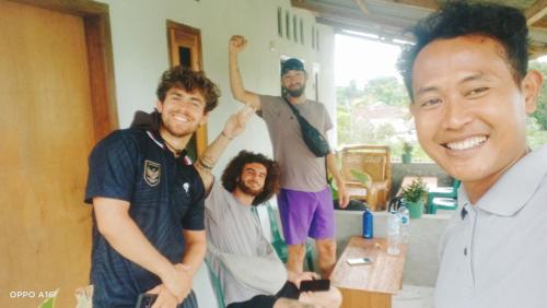 a group of men standing in a room at Twins Homestay ekas in Pulau Gilkaliantan