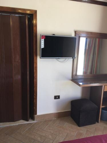a room with a flat screen tv on a wall at Abeer Hotel Alexandria in Alexandria
