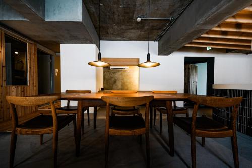 a dining room with a wooden table and chairs at Alternest Kamakura in Kamakura