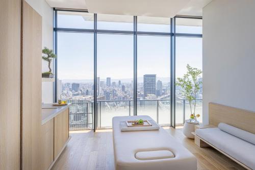 a living room with a view of a city at Four Seasons Hotel Osaka in Osaka