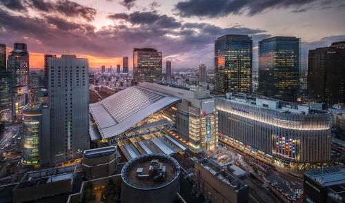 a view of a city at night with buildings at Four Seasons Hotel Osaka in Osaka
