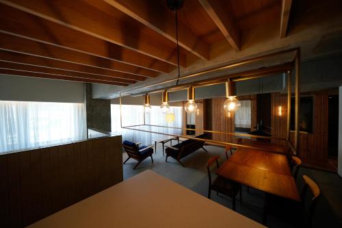 a dining room with a table and chairs and lights at Alternest Kamakura in Kamakura