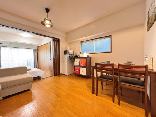 a living room with a bed and a dining room at Home Stroy in Tokyo-VENTI Okachimachi 東京屋語 in Tokyo