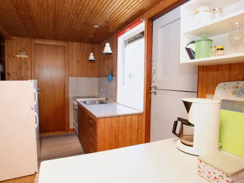 ÅlbækにあるIdyllic Beach Cottage - By Traum Ferienwohnungenの白い冷蔵庫とシンクのあるキッチン