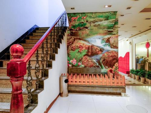 a mural on the wall of a staircase in a house at Shijia Inn On the Bund in Shanghai