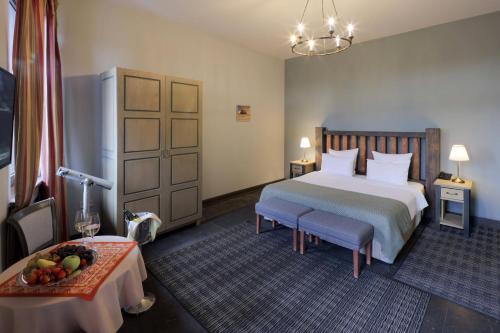 a hotel room with a bed and a table at Apricot Hotel Yerevan in Yerevan