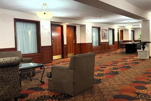 a lobby with chairs and a table in a building at Baymont by Wyndham Plainfield/ Indianapolis Arpt Area in Plainfield
