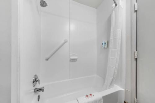 a white bathroom with a shower and a sink at Comfort Suites Milledgeville in Milledgeville