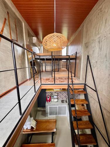 a staircase leading up to a room with a kitchen at LoftVibes San Juan La Union 2 in San Juan