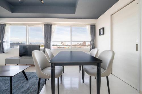 a dining room with a black table and chairs at Hills Garden 405 in Sapporo