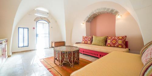 a living room with a couch and a table at The Way Inn - Boutique Suites in Safed