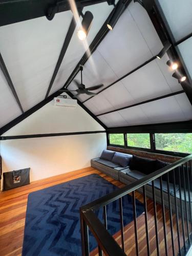 a living room with a couch in a tent at Royal Brick Cottage, Jelebu in Kuala Kelawang