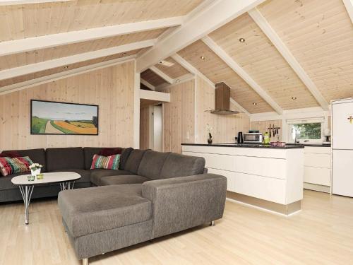 a living room with a couch and a kitchen at 9 person holiday home in Jerup in Jerup