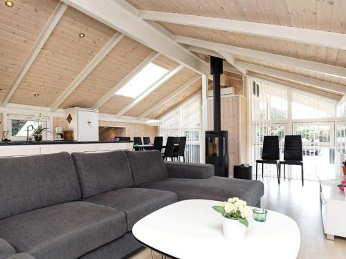 a living room with a couch and a table at 9 person holiday home in Jerup in Jerup