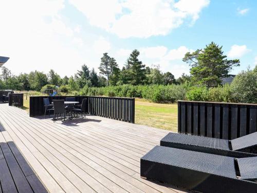a wooden deck with a table and chairs on it at 9 person holiday home in Jerup-By Traum in Jerup