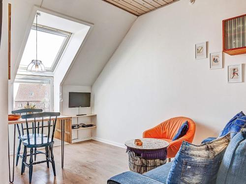 a living room with a couch and a table at 4 person holiday home in Gudhjem-By Traum in Gudhjem