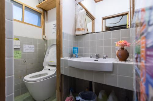 a bathroom with a sink and a toilet at Peace House Showa in Osaka