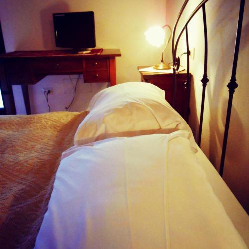 Postel nebo postele na pokoji v ubytování Agriturismo Pedru Caddu