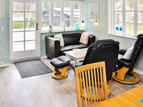 a living room with a couch and chairs and a table at 5 person holiday home in Ans By-By Traum in Roe