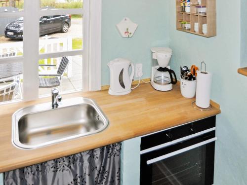 a kitchen counter with a sink and a window at 5 person holiday home in Ans By-By Traum in Roe