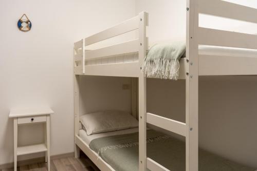 a bedroom with two bunk beds and a desk at Al Laghée - New 2 Bedroom Apartment in Gravedona Center in Gravedona