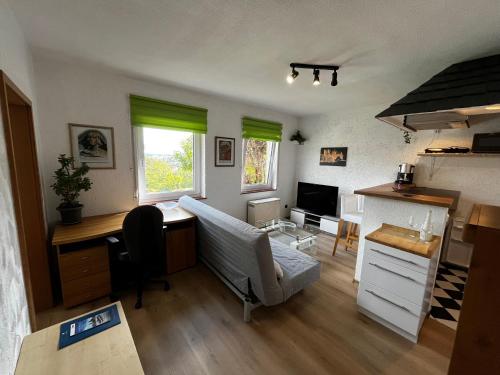a living room with a desk and a couch at Haus Ehrenfels in Bingen am Rhein