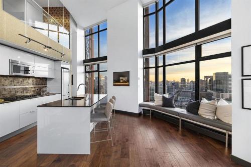 a kitchen and living room with a view of the city at 3-Level Modern Luxury Sub-Penhouse, Best Ocean & City Views - Prime Downtown Location in Vancouver