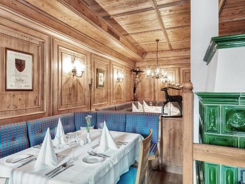 a dining room with two tables with white napkins at Dolomiten Residenz - Sporthotel Sillian in Sillian
