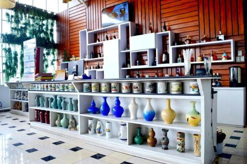 a display of vases on shelves in a store at Grant Hotel Subang in Bandung