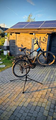 a bike parked on a stand in front of a house at Na Kocankach - Kocanka 1 