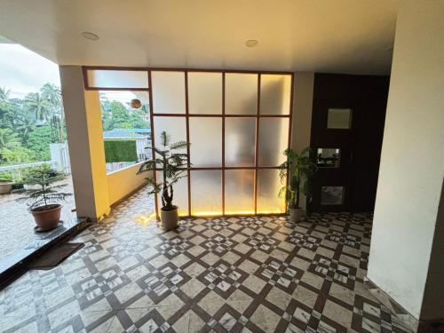 an empty room with plants in a building at SeaScape Port Blair in Port Blair