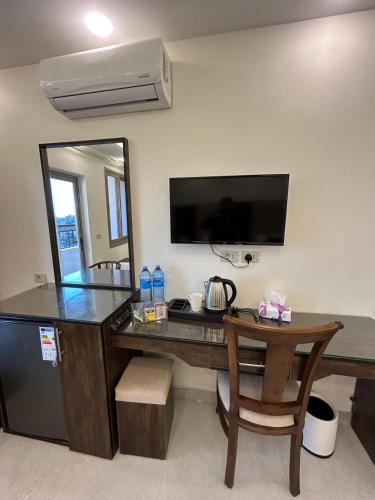a room with a desk with a computer and a mirror at Petra Brothers in Petra