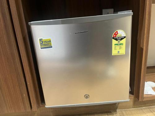 a metal refrigerator with two stickers on it at Nirvana Grand Hotel & Resort in Gaya