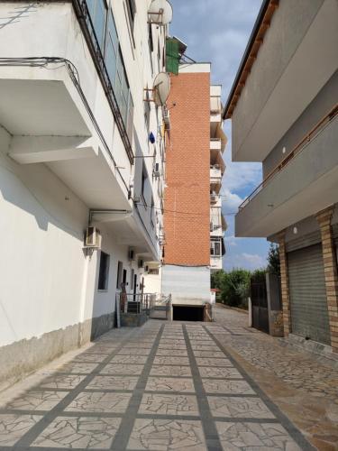 an alleyway between two buildings in a city at KC Apartments 3 in Berat