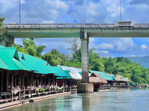 a train on a bridge over a river at The For Rest Resort in Sai Yok