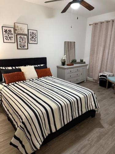 a bedroom with a bed with a black and white striped blanket at Mdelight Lodge in Frisco