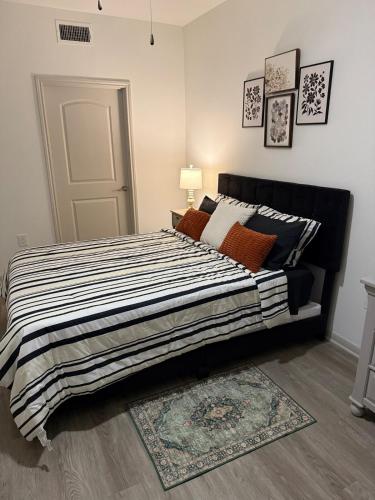 a bedroom with a bed with a black and white comforter at Mdelight Lodge in Frisco